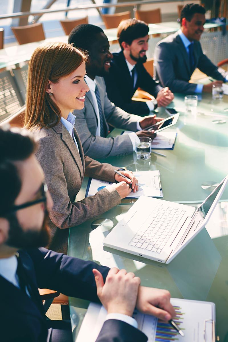 A group of buisness people sitting in a conference room