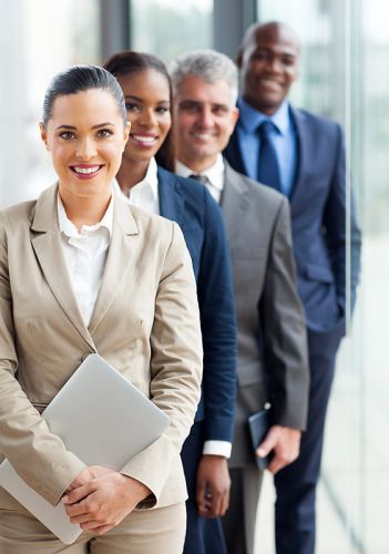 A well dressed corporate team stands together