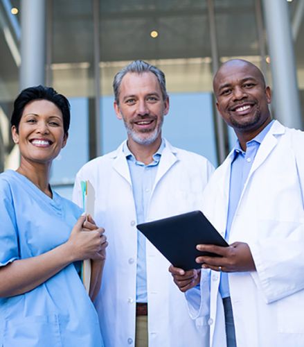 Three medical staff stand together