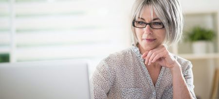 Woman With Glasses Thinking About Making An Eye Appointment