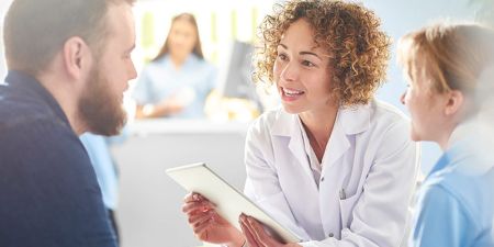 young female doctor talking to patient